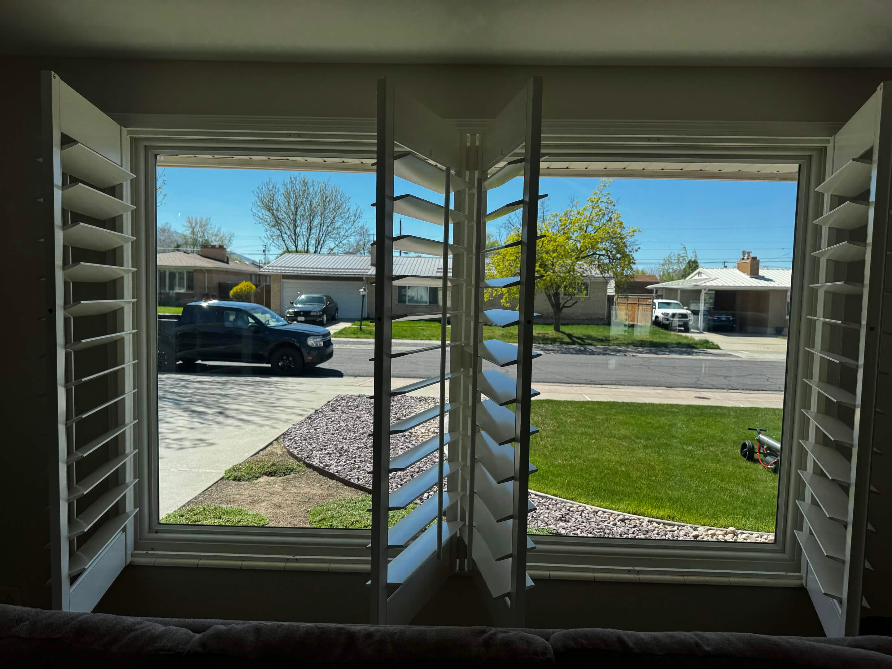 A bright, spotless window looking out over the neighborhood after an interior clean.
